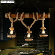 Rustic wooden beam pendant light with beige rope wrapping and three hanging wire cage lanterns for kitchen island lighting