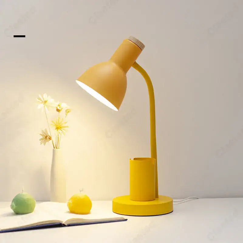 Yellow desk lamp with curved neck and integrated cylindrical pen holder, ideal for decorbites cute nordic bedroom use