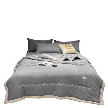 Gray quilted decorbites cooling cotton quilt with wavy stitching and beige trim for breathable bedroom blanket