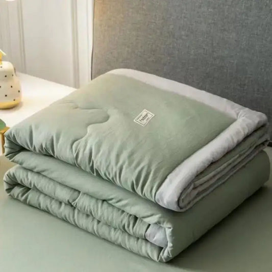 Sage green and white cooling cotton quilt bedroom blanket with plush lining and subtle stitching from decorbites cooling cotton