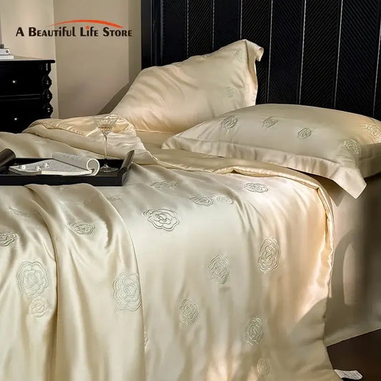 Cream-colored satin quilt set with delicate silver eucalyptus fiber flower embroidery for elegant bedroom decorbites