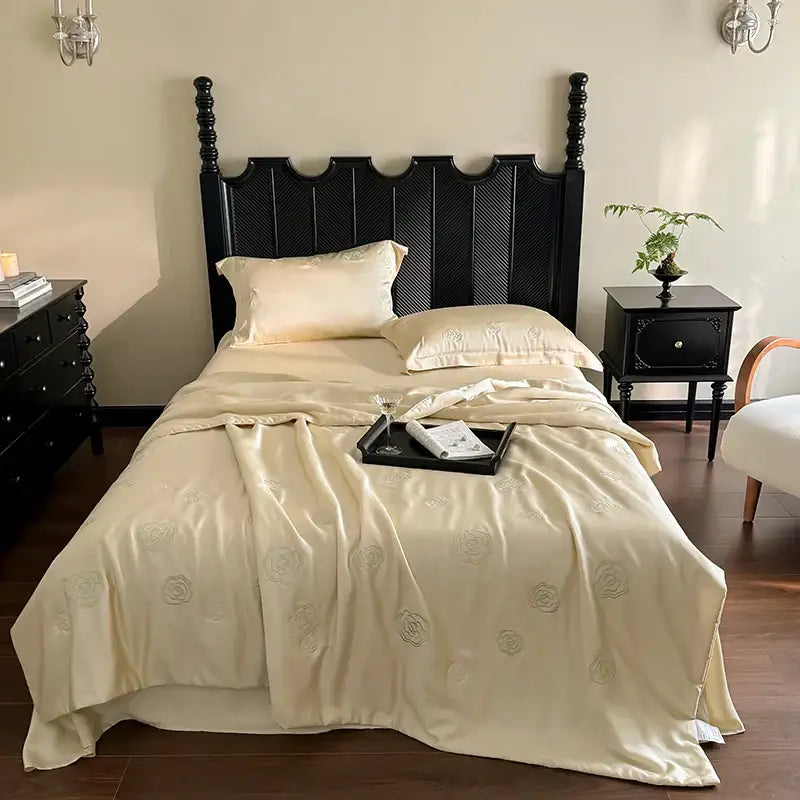 Cream-colored satin quilt set with subtle eucalyptus fiber flower embroidery for elegant bedroom decorbites decor