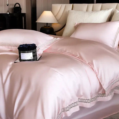 Pink satin duvet cover with delicate black lace trim as part of a satin cream and gold lace eucalyptus duvet cover set