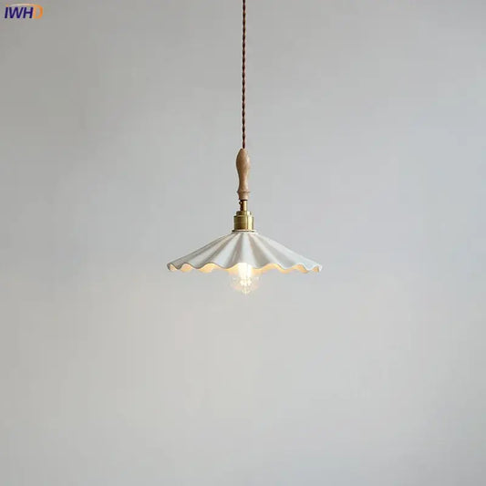 Scalloped white ceramic led pendant light with brass fixture and wooden handle hanging from braided cord decorbites ceramic led pendant