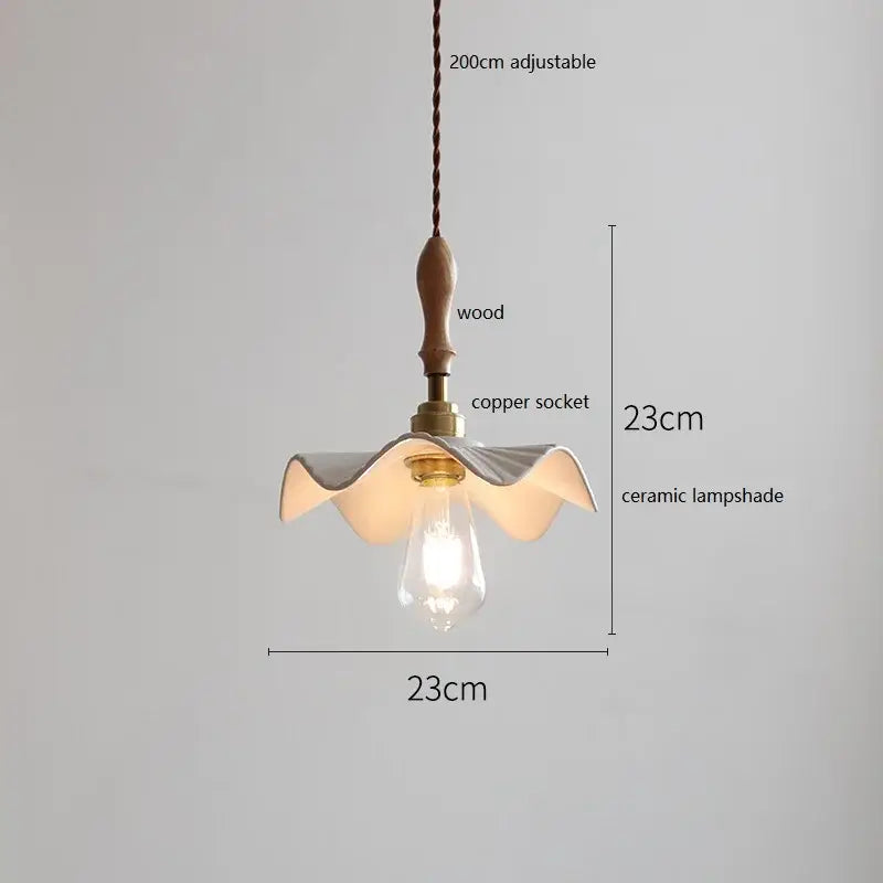 Scalloped white ceramic led pendant light with a wavy petal design hanging from a wood and copper fixture decorbites ceramic led