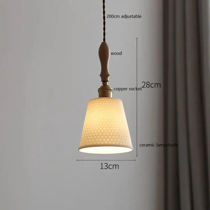 Scalloped white ceramic led pendant light with textured honeycomb pattern hanging from wood and copper socket