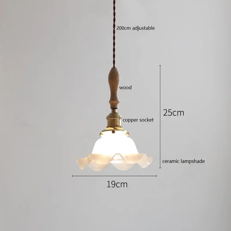 A scalloped white ceramic led pendant light with a wooden handle and copper socket on a 200cm braided cord