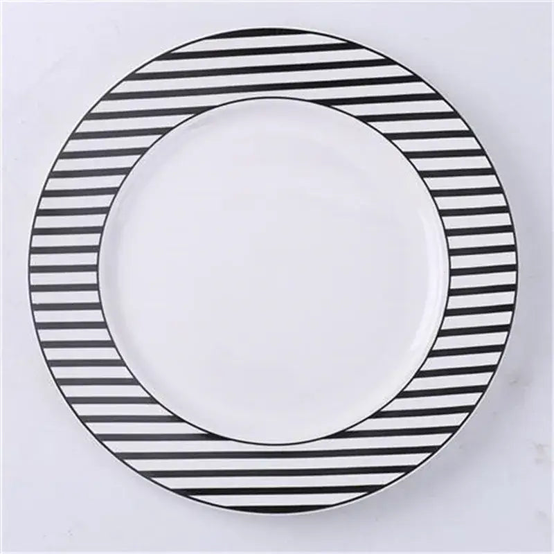 A round white ceramic dessert plate with a bold black and white striped border from decorbites ceramic dessert plates