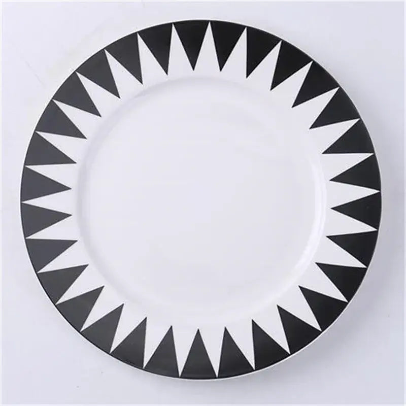 White ceramic dessert plates with bold black triangular geometric pattern around rim from decorbites ceramic dessert collection