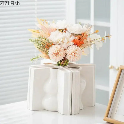 White ceramic vase shaped like an open book with textured wavy design for creative flowers desk decoration decorbites