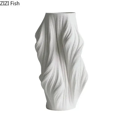 A sleek white decorbites ceramic vase with a sculpted flowing fabric design and purple flowers for bedroom decor