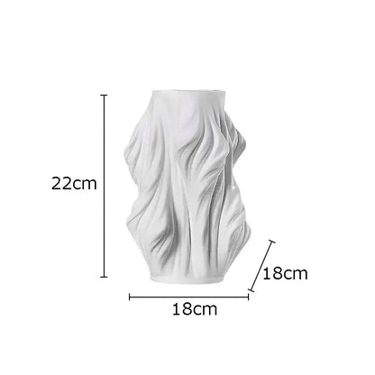 White sculpted ceramic vase with flowing fabric design and purple flowers for bedroom decor by decorbites ceramic vase