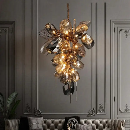 Sculptural gold pendant light with glass shades featuring faceted amber crystals and mirrored elements for dining room
