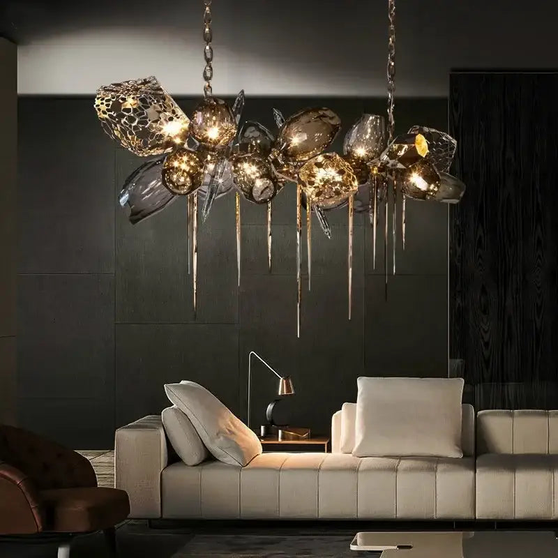 Sculptural gold-toned pendant light with glass shades and metallic drips for dining room chandelier lighting