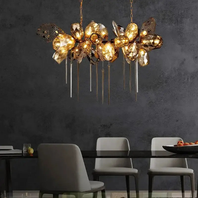 Sculptural gold glass shades pendant light featuring faceted glass orbs and metallic rods for dining room chandelier