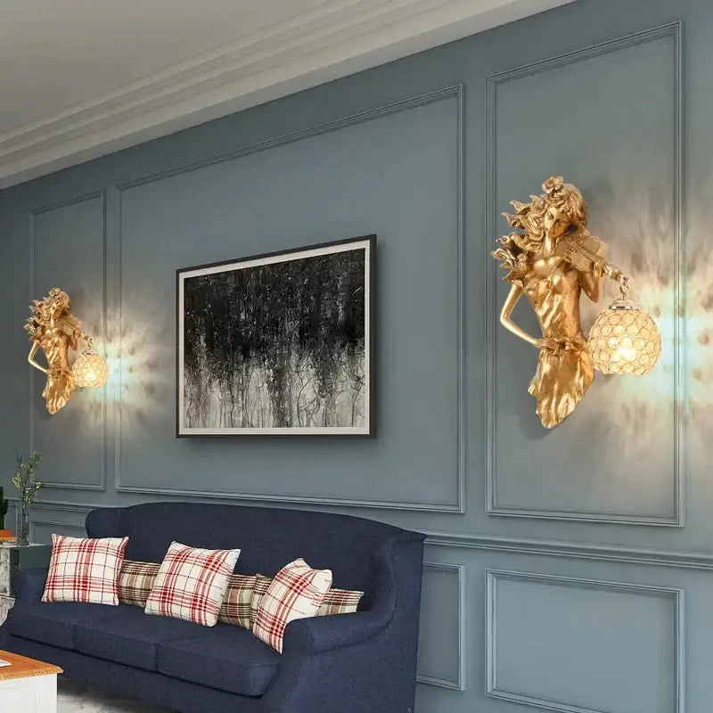 Sculptural gold wall lamp featuring a violinist maiden with flowing hair and ornate crystal wall globe shade