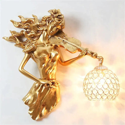 Sculptural gold wall lamp featuring a violinist with flowing hair and an ornate crystal globe crystal wall lamp shade