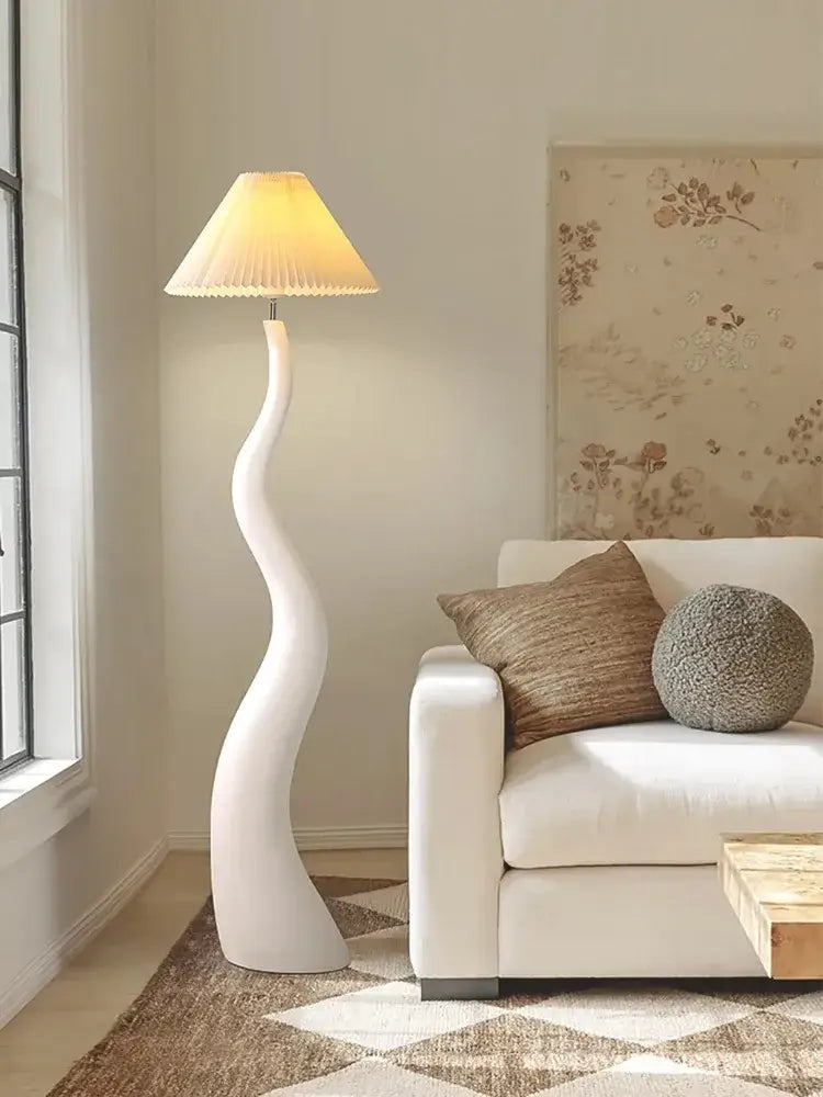 Sleek white cream resin floor lamp with curved design and beige pleated shade ideal for living room decorbites lighting