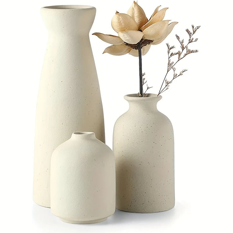 Set of three cream-colored speckled ceramic vases with minimalist modern shapes for rustic and farmhouse decor