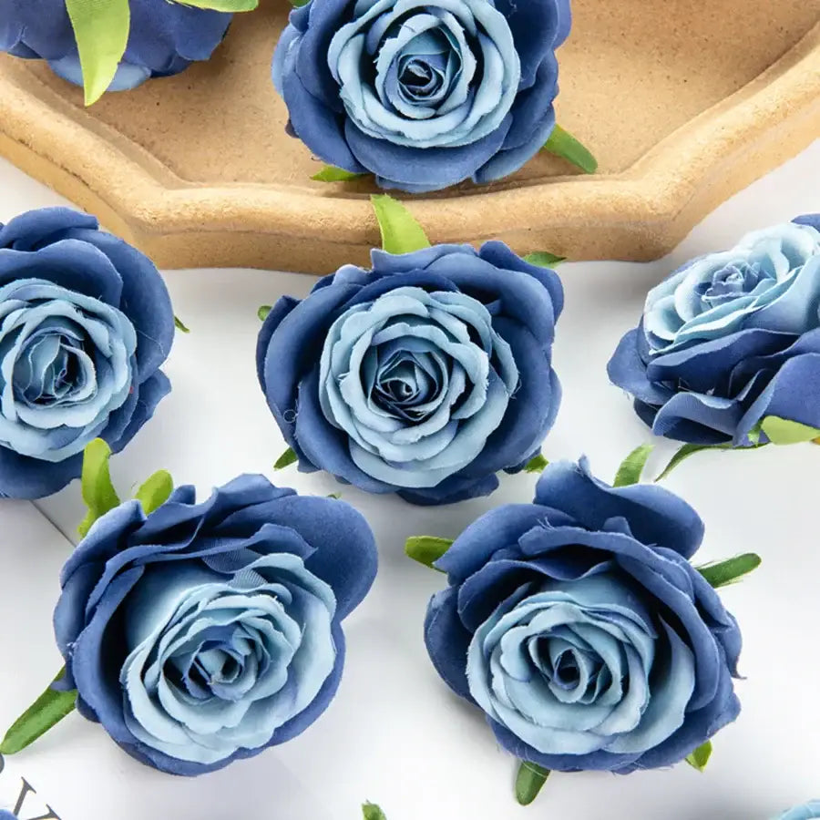 Silk blue artificial flowers featuring layered petals and green stems, ideal for wedding party decor and bedroom rose arrangements
