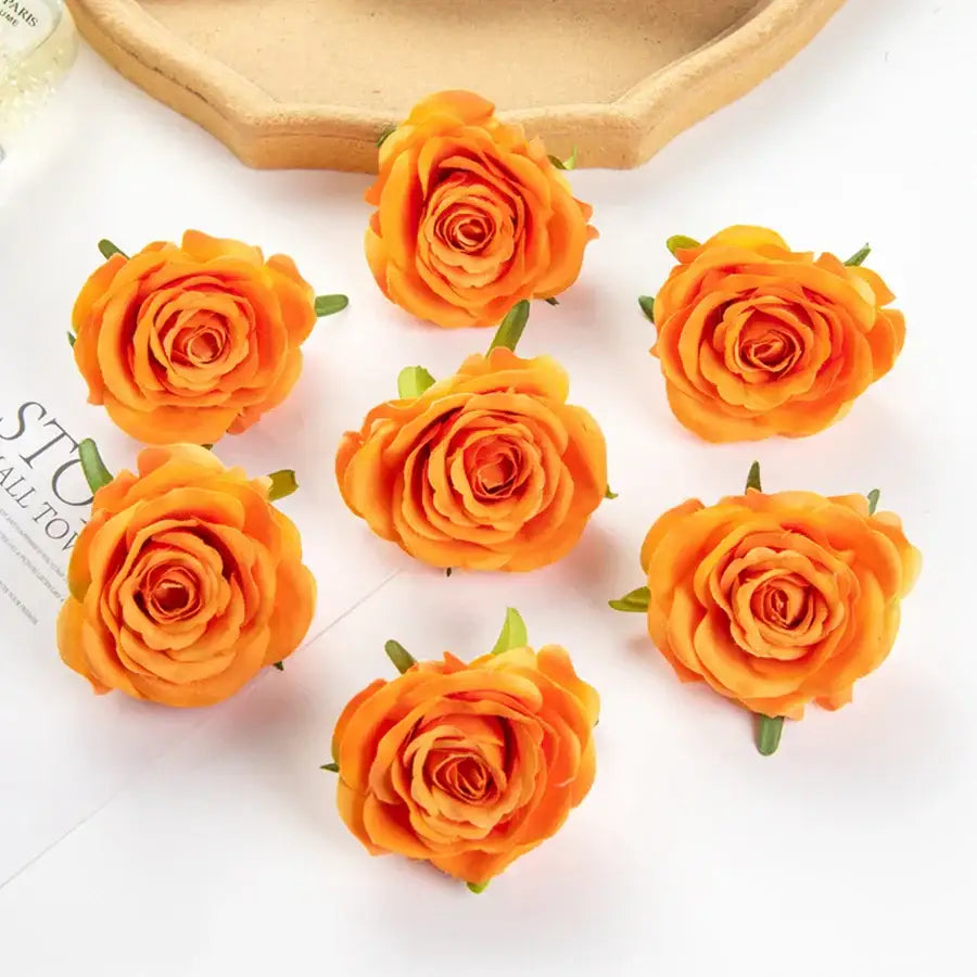 Vibrant orange artificial flowers with detailed petals and green stems for silk blue rose wedding party decor