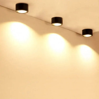 Three sleek black cylindrical 15w cob led downlights recessed for exhibition and decorative lighting emit warm illumination