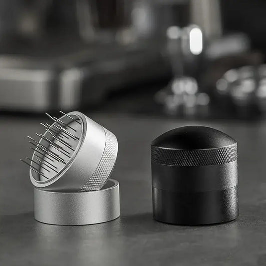 Silver and black decorbites coffee needle distributor with textured grips and fine metal tines for espresso stirring