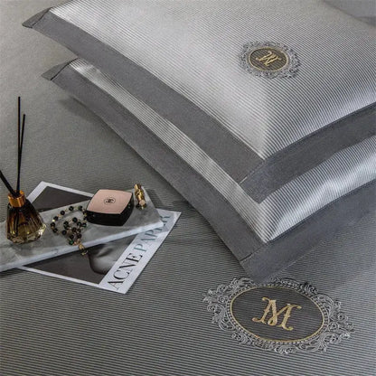 Gray striped pillowcases with gold embroidered monogram m on the front from silver carbon light cooling mat bed sheet set