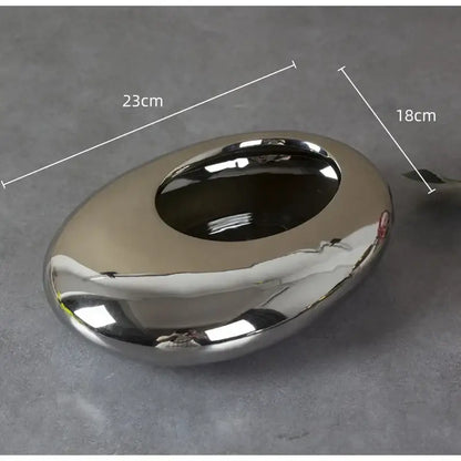Shiny silver cobblestone ceramic oval ashtray with smooth reflective surface and rounded edges for decorbites living room decor