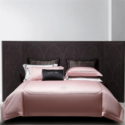 Pink satin bedding set with matching pillowcases and black lucky day accent pillow in decorbites cotton satin jacquard