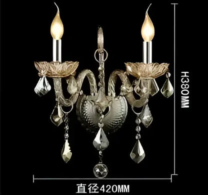 Silver-toned decorbites crystal cognac wall lamp with ornate heart-shaped design and dangling crystal droplets for luxury decor