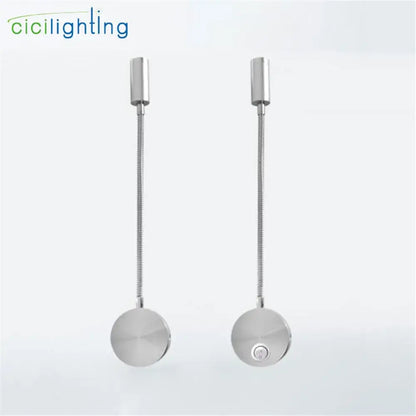 A pair of silver flexible gooseneck led wall sconces with adjustable metallic arms and circular bases for bedroom reading