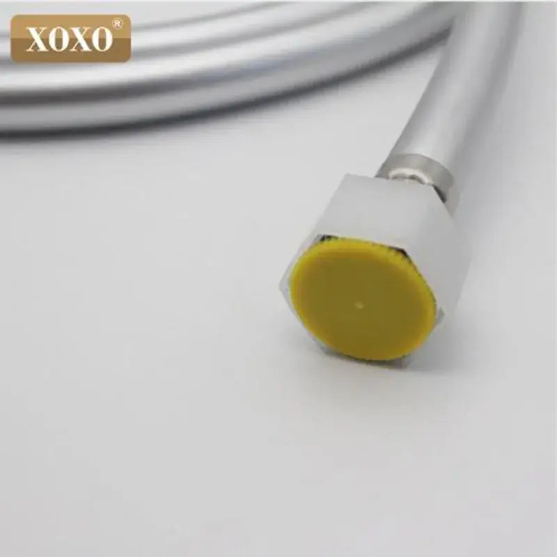 Silver pvc flexible shower hose with metallic spiral connector and yellow plastic cap for bathroom use