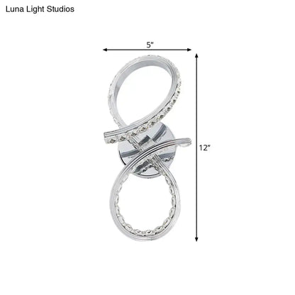 Simple led chrome infinity wall sconce with silver cut crystal deco accents and warm white light for bedroom use