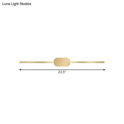 A sleek gold metallic wall mounted vanity sconce with a simple style and oval central accent for bedroom use