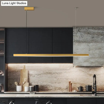 Gold-colored metal simplicity led pendant light with bulb included hanging above dining room kitchen counter