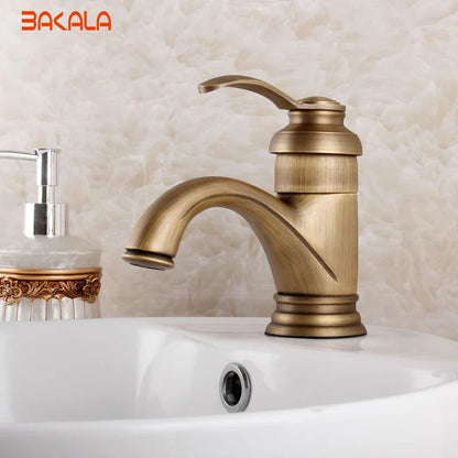 Antique brass single hole deck mounted bathroom faucet with single handle curved spout and decorative ridged base
