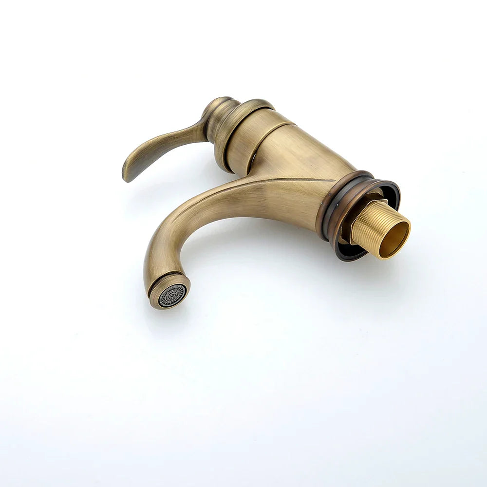 Antique brass single hole deck mounted bathroom faucet with curved spout and decorative ridged handle vintage style