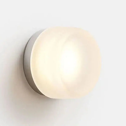 Sleek gold round wall sconce with frosted glass globe and brushed metal base for modern minimalist lighting