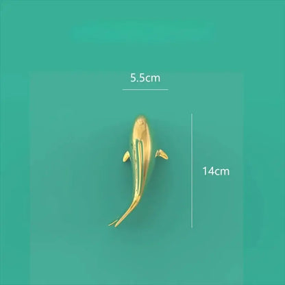 A sleek goldfish resin wall hanging with a polished golden metallic finish and detailed fins for living room decorbites decor
