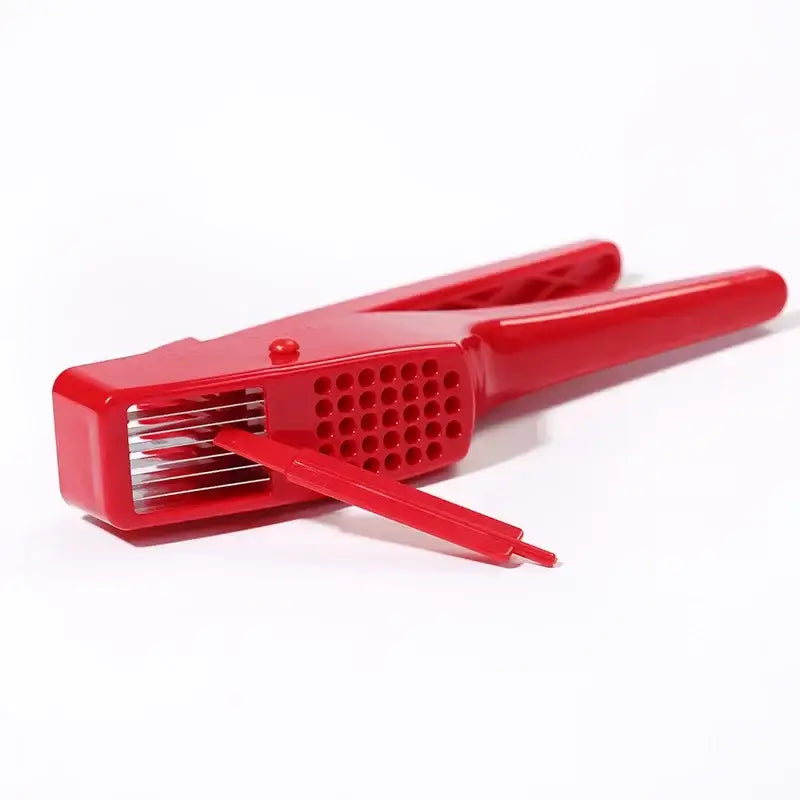 Sleek red manual press garlic crusher with metallic blades and perforated grip by decorbites garlic crusher