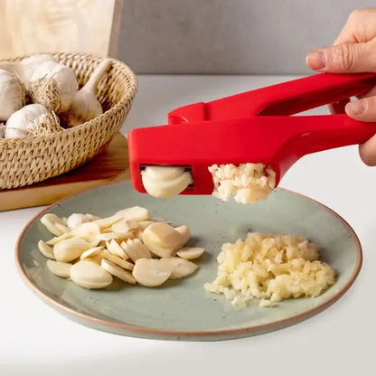 Sleek red silicone manual garlic crusher by decorbites designed for efficient kitchen grinding and crushing tasks