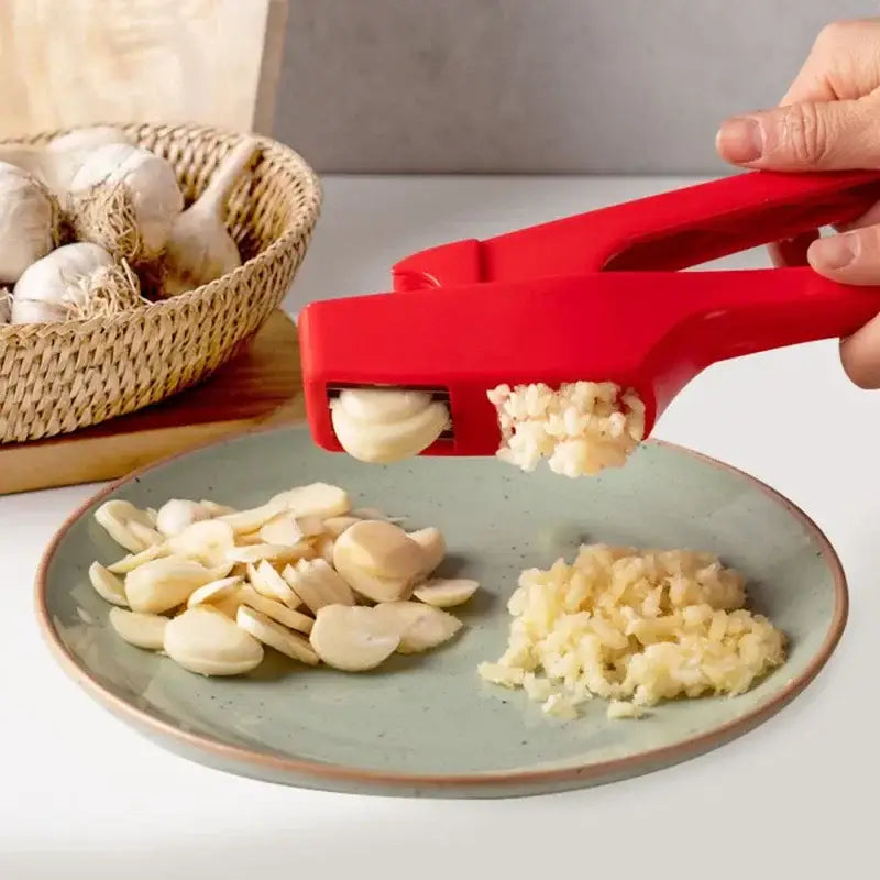 Sleek red silicone manual garlic crusher by decorbites designed for efficient kitchen grinding and crushing tasks