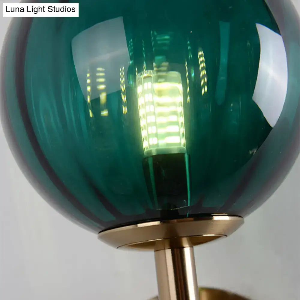 Teal glass globe lamp with brass base and led bulb as part of sleek round wall lighting red green amber bedside sconce light