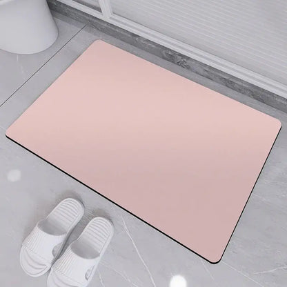 A sleek pink rubber bath rug with a smooth surface and black border for non-slip diatom ooze bath use