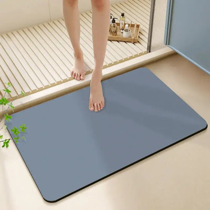 Blue rectangular non-slip bath rug with black border made of diatom ooze for bathroom use