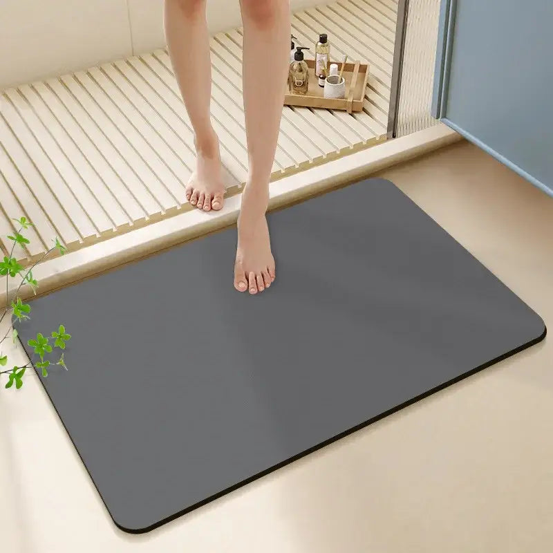 A sleek dark gray rectangular bath rug with rounded corners made of diatom ooze for a non-slip bathroom mat