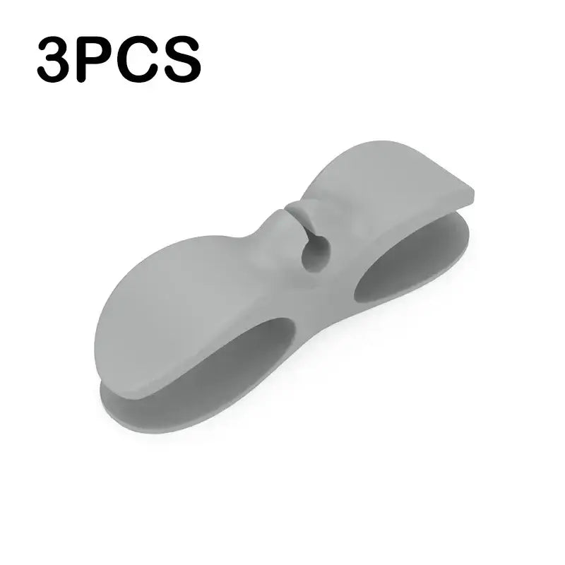 Gray silicone decorbites cord winder cable organizer with sleek bow shape and two open slots for cord management