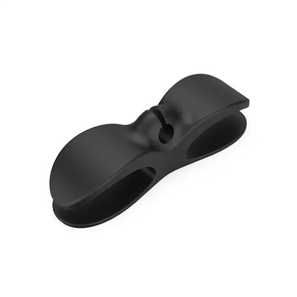 Black plastic decorbites cord winder with sleek bow-shaped design and smooth edges for cable organizer use
