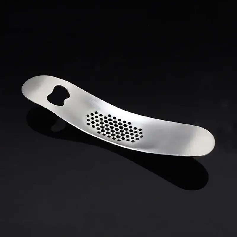 Silver stainless steel decorbites garlic press with sleek curved design and evenly spaced circular holes for easy crushing